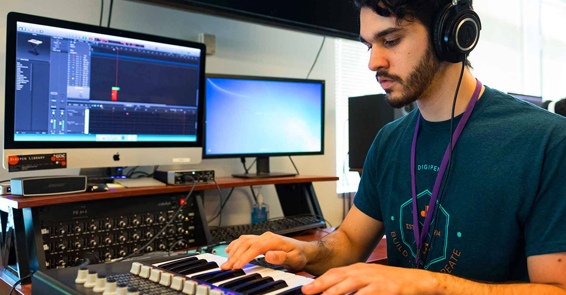 high school student male playing keyboard and using computers
